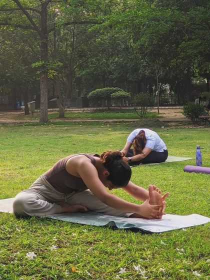 A student works on Janu Sirsasana (Head-to-Knee Forward Bend) in our park session. I teach variations to make poses like this accessible for everyone, regardless of their flexibility.
