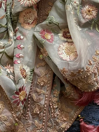 A macro shot of the dupatta's border and the floral embroidery.