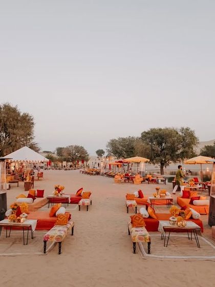 The Mehendi Sundowner was held amidst the desert dunes, with a theme inspired by the colorful Banjara tribe of Rajasthan. The setup featured low seating, vibrant textiles, and rustic decor.