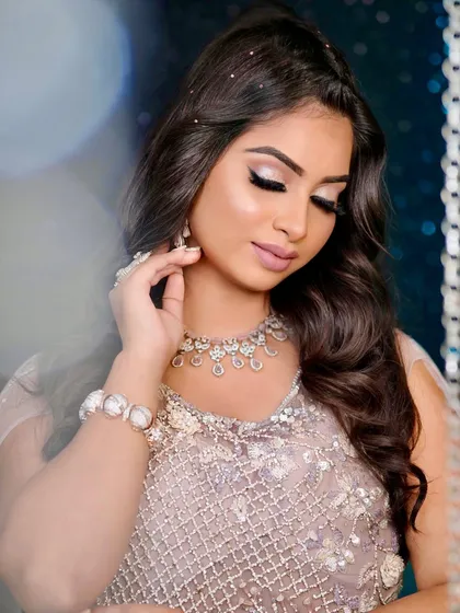 A soft, romantic portrait that focuses on the flawless skin and the delicate sparkle of the diamond jewellery.