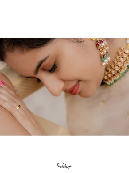 A delicate close-up of the bride-to-be, highlighting her serene expression and beautiful traditional jewelry.