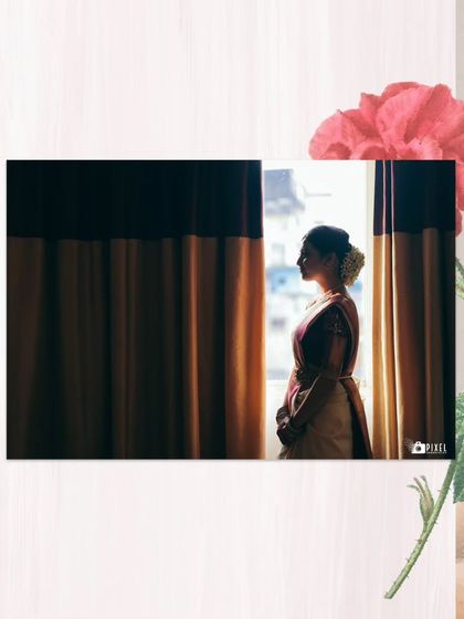 A silhouette of the bride looking out the window, a moment of quiet contemplation before the ceremony.