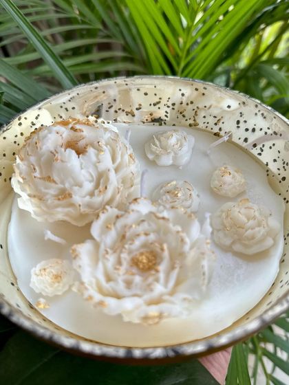 Another angle of the peony bowl candle, showing the delicate details and the shimmer of the gold paint on the wax flowers.