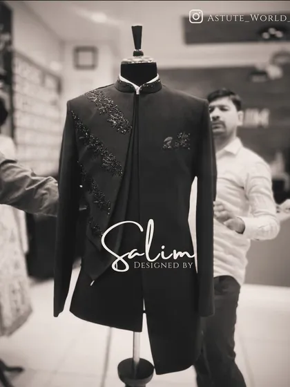 A black Indo-Western jacket with an asymmetrical drape and subtle black-on-black embroidery. The focus here is on the unique cut and understated texture.