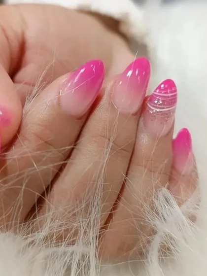 A bright pink ombre set with a creative twist, featuring a silver glitter accent nail with delicate white line art.