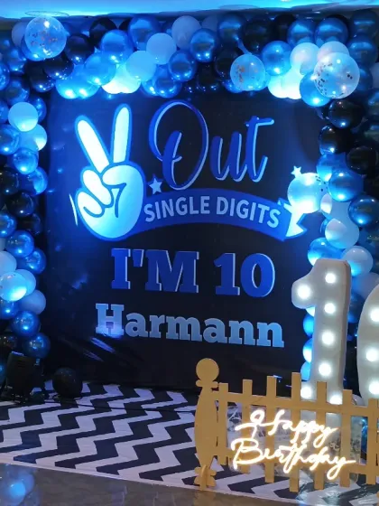 A closer look at the lit-up '10' and the custom backdrop for this stylish 10th birthday party.