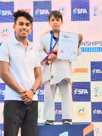 This young fighter with his medal and certificate. He has a bright future ahead of him in martial arts.