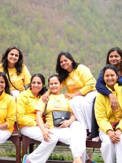 A group of women from a past TTC, smiling for a photo. The course is an empowering experience that creates a strong sisterhood.