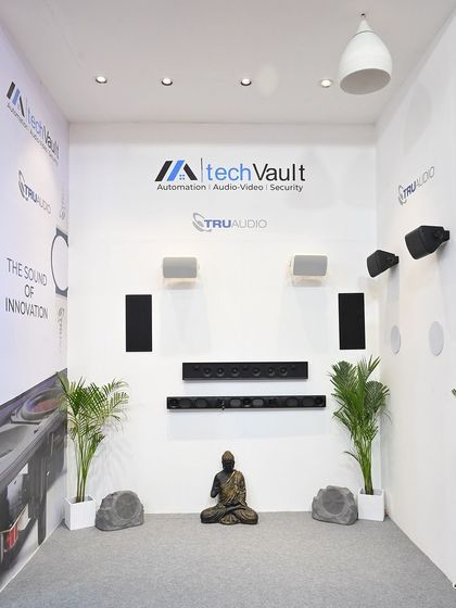 Our showroom display features a variety of integrated audio solutions from TruAudio. You can see different types of in-wall speakers, soundbars, and even rock speakers, demonstrating the range of options we offer for seamless, high-performance sound.