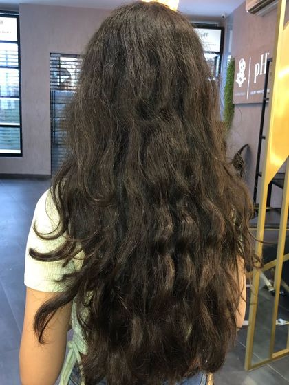 This is the 'before' shot, showing long, naturally dark hair ready for a sun-kissed makeover.
