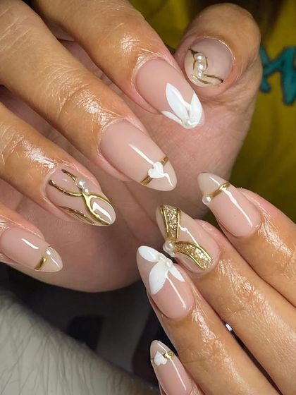 An elegant and artistic set with a nude base, delicate white hearts, and intricate gold line art.