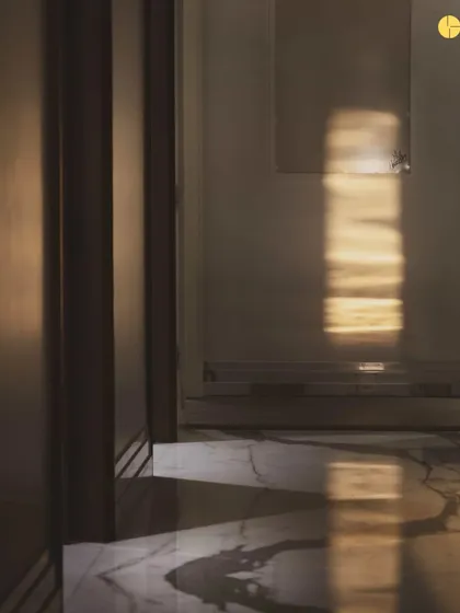 A moment of quiet observation in the empty 'Canvas' apartment. The light streaming in from the window casts shadows on the marble floor, offering the first clues for the design to come.