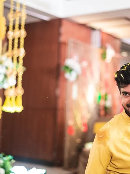 The groom's happy and slightly mischievous smile during the haldi ceremony.