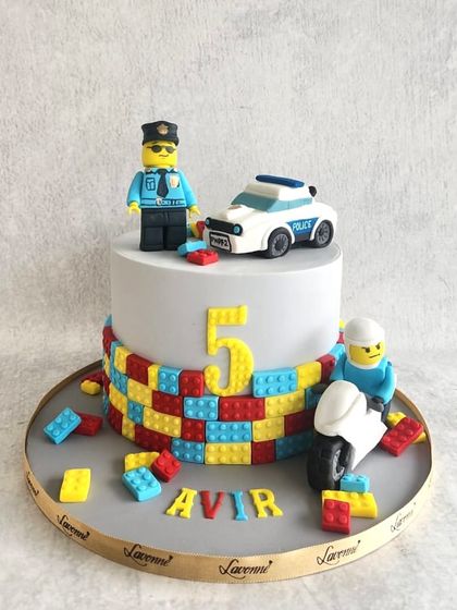 A Lego police-themed cake for Avir's 5th birthday. We created a fun scene with a Lego policeman, a police car, and lots of colourful Lego blocks.