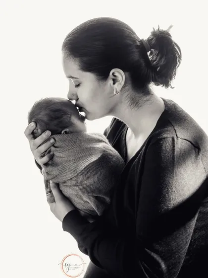 A timeless black and white portrait of a mother's love. This intimate moment is a powerful and emotional keepsake.