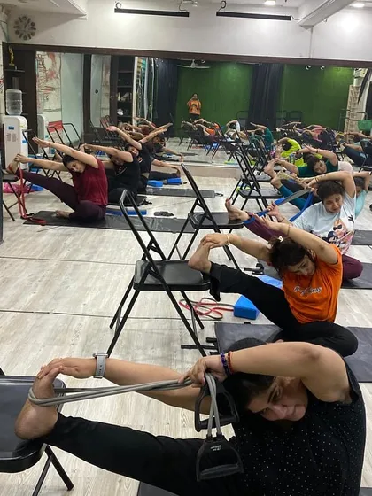 Using straps and chairs to deepen a forward fold, allowing for a safe and effective hamstring stretch.