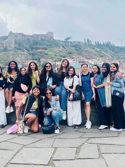 A group of amazing women posing with the stunning backdrop of Tbilisi. Our trips are designed for making connections and exploring incredible places together.