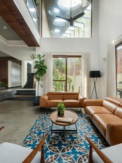 Natural light is a key material for us. In this living area from the 'Jodi Mane' project, a double-height ceiling and large windows create a sense of grandeur and openness, making the space feel bright and connected to the outdoors.