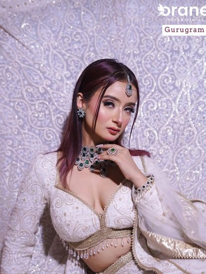 A striking look with a white lehenga and dark, wine colored hair. I teach my students to create makeup that harmonizes with unconventional and modern styling choices.