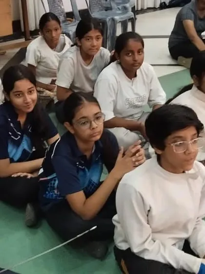 A group of our young fencers listening intently during a debrief. We create a focused learning environment where students are encouraged to absorb every piece of guidance.