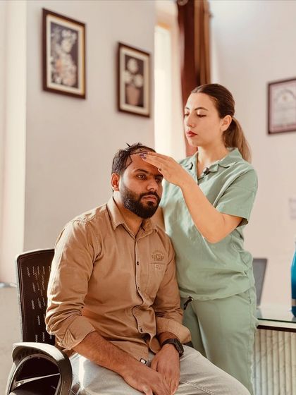 A female Turkish expert consulting with a patient, designing the perfect hairline. We ensure our patients are comfortable and confident before the procedure begins.