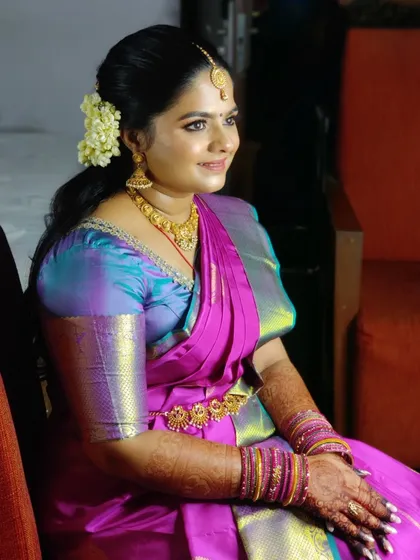 A seated portrait of Pavitra, looking like a royal bride. The makeup, hair, and traditional saree draping all came together to create a flawless engagement look.