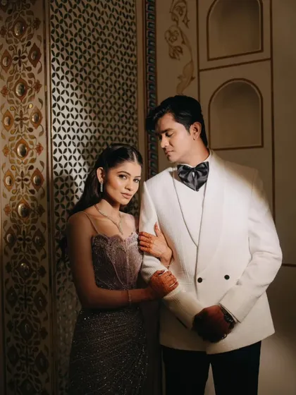 An elegant couple portrait from a royal sangeet in Ajmer. We focus on the connection between two people, using dramatic lighting and the regal backdrop of Pratap Mahal to create a timeless, editorial feel.