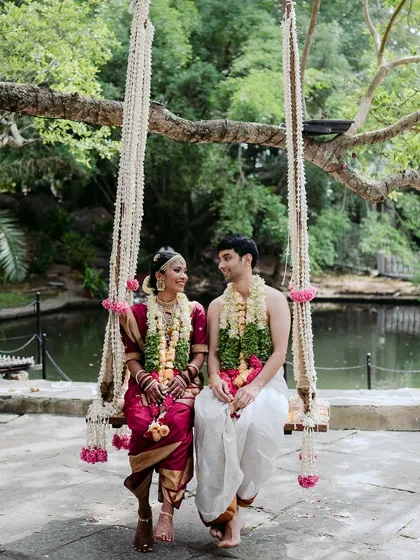 A classic romantic portrait of a couple on our floral-decorated swing by the pond. This iconic spot at The Tamarind Tree is a favorite for capturing cherished wedding memories.