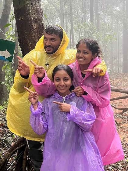 A fun family photo pointing at the "Kurinjal" sign in Kannada. Our treks are for everyone!