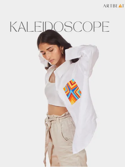 The Kaleidoscope hemp boyfriend-fit shirt. The pocket features a vibrant, geometric artwork that adds an element of surprise and color to the crisp white shirt. It’s an easy-breezy piece for summer.