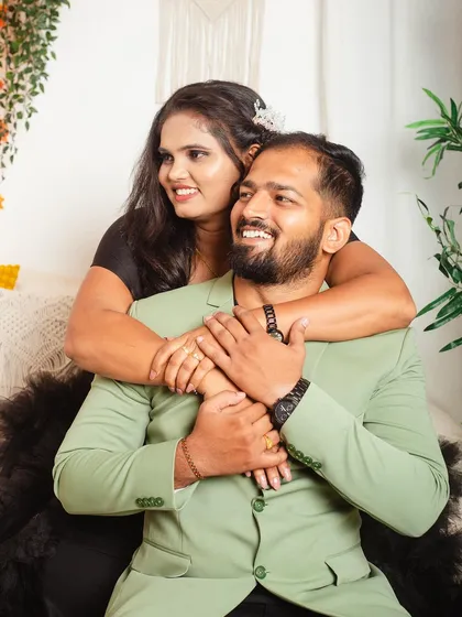 A loving embrace during a couple's photoshoot in our boho bedroom setup. The contrast of the black gown against the light, airy background creates a sophisticated look.