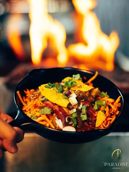 Fire and flavor come together in our live Chinese cooking station. A chef stir-fries noodles and vegetables over a high flame, creating a dish that is full of smoky goodness.