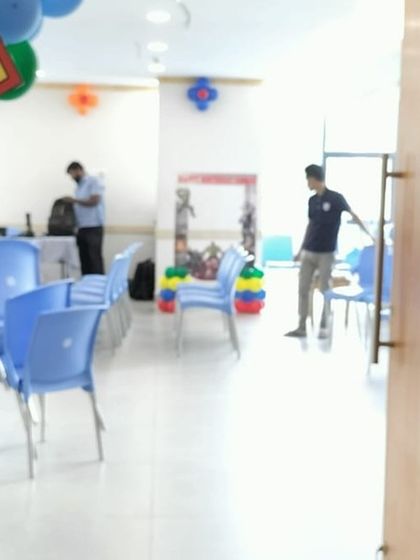 A superhero themed balloon arch at the entrance, featuring logos like Superman and comic book sound effects.