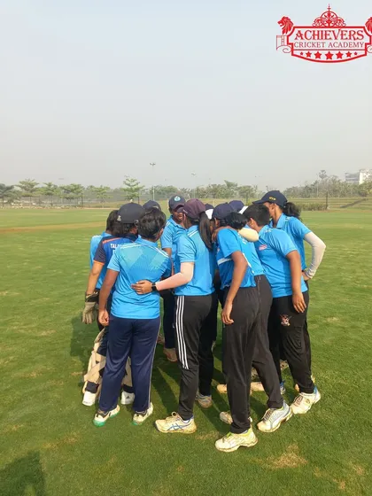 A team huddle before the game. We foster a strong sense of teamwork and camaraderie in our girls' squad.