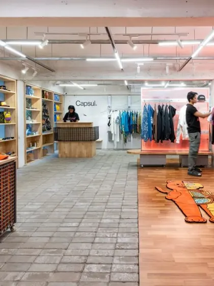 For Capsul in Mumbai, we transformed a former bank into a gritty, adaptive retail environment. The design uses raw materials like concrete pavers and wood, creating distinct zones that encourage exploration, while a custom lighting grid sets a dynamic, urban mood.