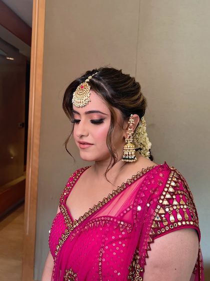 A close-up of the Mehendi look, focusing on the soft pink eyeshadow and flawless finish.