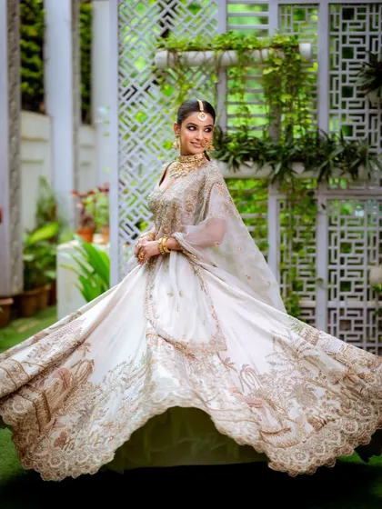 I love the movement and grace of a bridal lehenga. This shot captures the full splendor of an ethereal white and gold ensemble, where the makeup was designed to be soft, dreamy, and absolutely radiant from every angle.