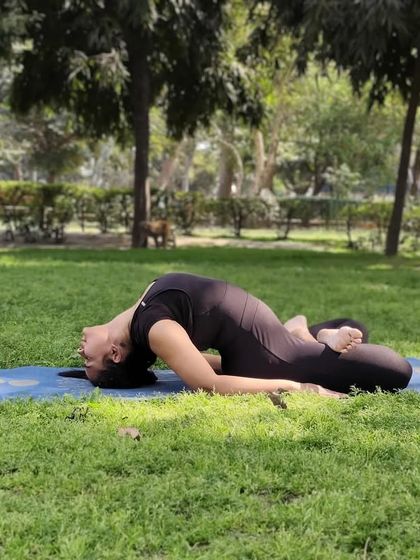 Matsyasana, or Fish Pose, being practiced outdoors. This posture provides a deep stretch to the neck and chest, expanding the rib cage and promoting better breathing, making it a key therapeutic asana for respiratory health.