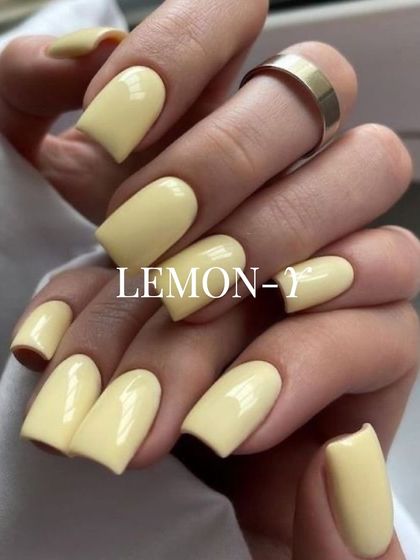 A soft, buttery lemon-yellow on square-shaped nails. This cheerful pastel shade is perfect for spring and summer, adding a touch of sunshine to your look.