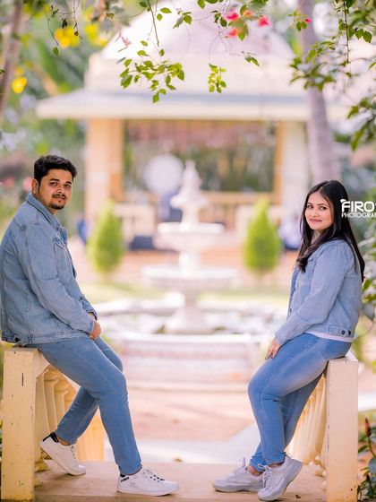 A casual and relaxed couple's portrait in matching denim, with the garden fountain in the background.