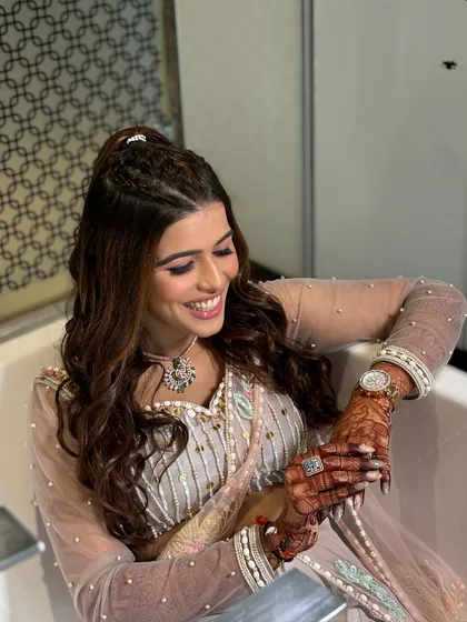 Glamorous, playful, and ready to dazzle. This look, with its unique draped saree-style outfit and soft glam makeup, is perfect for a carnival-themed event or a fun sangeet.