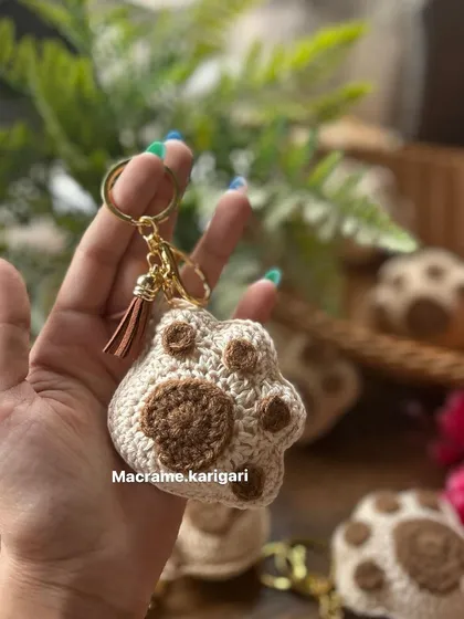Holding up the paw keychain to show its size and detail. It’s a small but meaningful accessory for any pet parent.