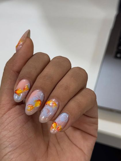 Something's fishy, and I love it. This design features delicate, hand-painted goldfish swimming in a dreamy, marbled water background.