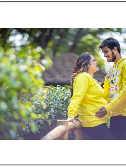 A casual and sweet moment between a couple in matching sweatshirts, enjoying their time together in the park.