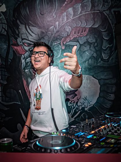 Pointing to the crowd, inviting them to join in the energy. It's a two-way street.