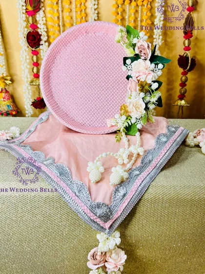 Another view of our pastel pink floral thali, highlighting the beautiful gota patti work on the thali cover.