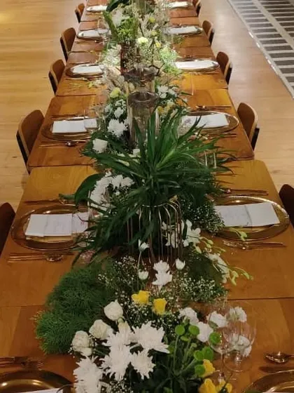 A beautifully set long table for a sit-down dinner we hosted for WeWork. We handle all the details, including floral decor and place settings, to create an elegant atmosphere for corporate events.