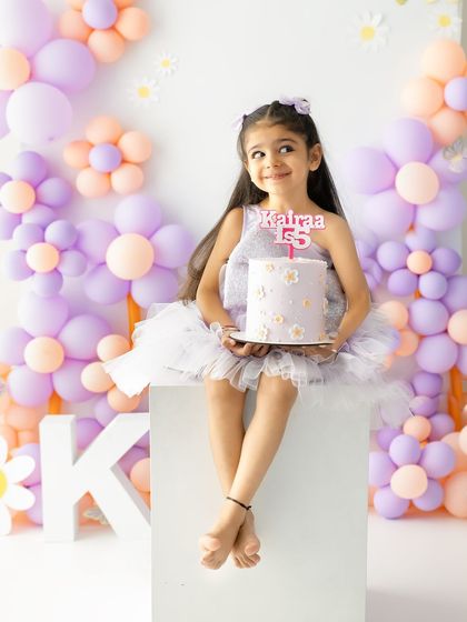 A thoughtful look as she holds her birthday cake. These quiet moments are just as precious as the big smiles during a milestone session.