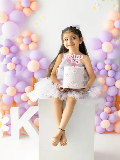 A thoughtful look as she holds her birthday cake. These quiet moments are just as precious as the big smiles during a milestone session.