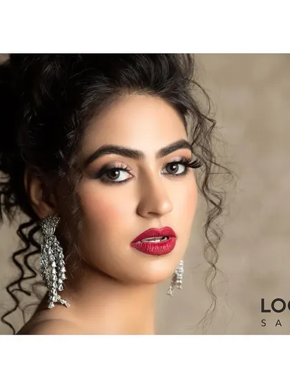 This is a classic glam party makeover, perfect for making a statement at any event. I created a bold red lip and defined eyes, paired with a sophisticated updo, to craft a look that is both powerful and elegant.